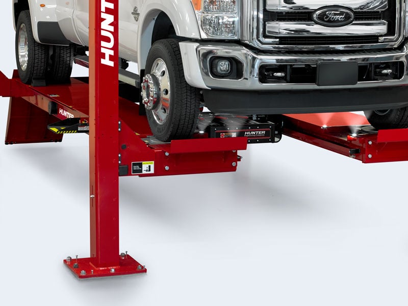 white truck on four post lift