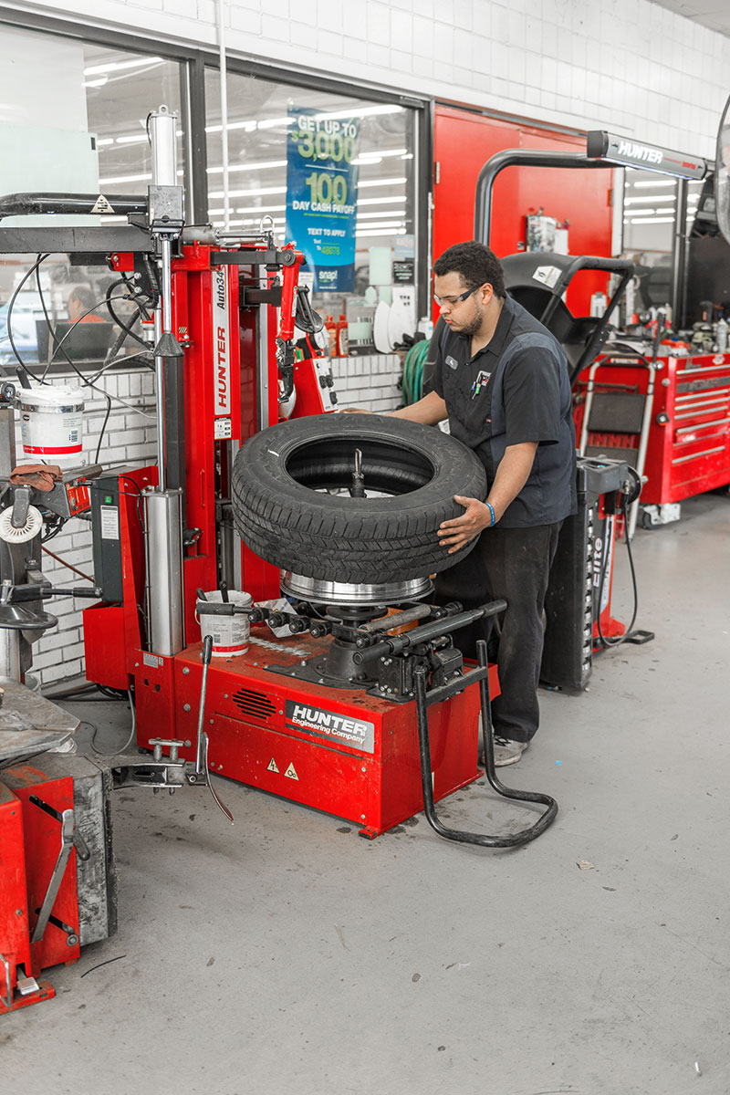 tc-tca-realshop-purperformance2.jpg tech lifting tire off of auto34s tire changer