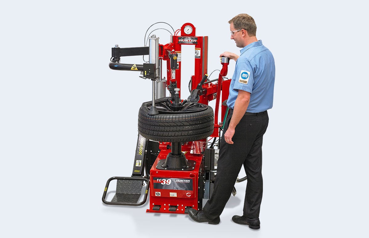tech using foot pedal control on tc39 tire changer