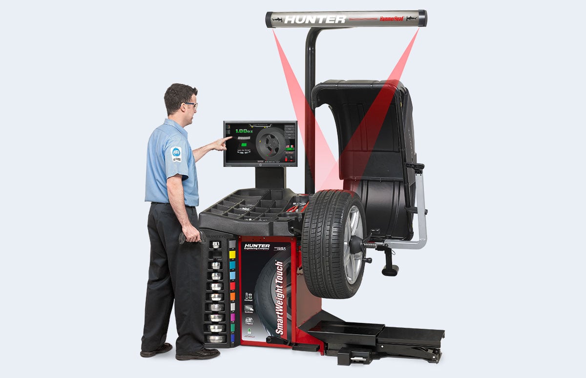 technician using smartweight touch wheel balancer